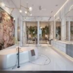 Explore this luxurious bathroom featuring modern decor, marble surfaces, and a freestanding bathtub.