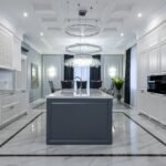 Interior of contemporary spacious kitchen with light expensive furniture placed in apartment with minimalistic design