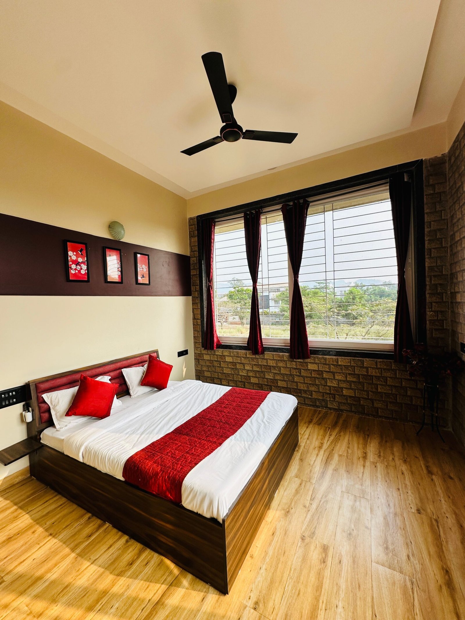 Contemporary bedroom interior with red accents, offering a scenic view. Perfect for comfort and style seekers.