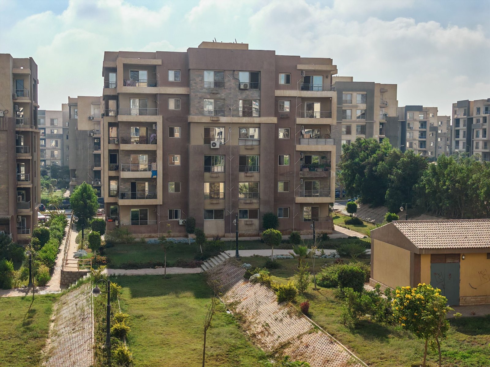Aerial view of residential apartment buildings surrounded by greenery.