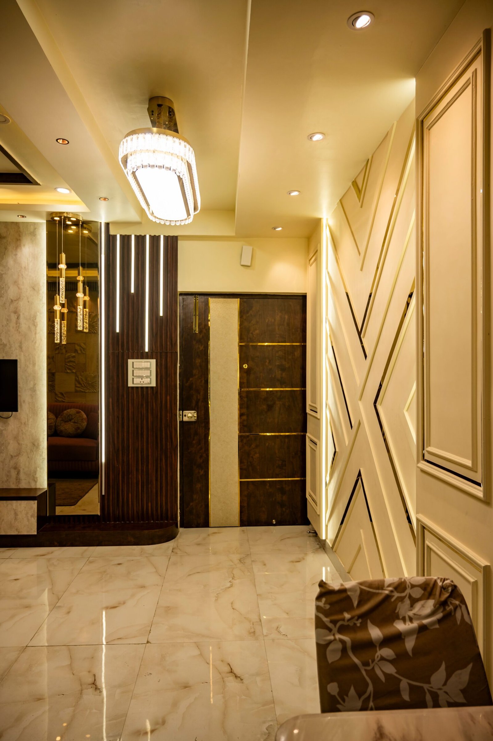 Luxurious hallway interior with geometric wall designs, modern lighting, and marble flooring.