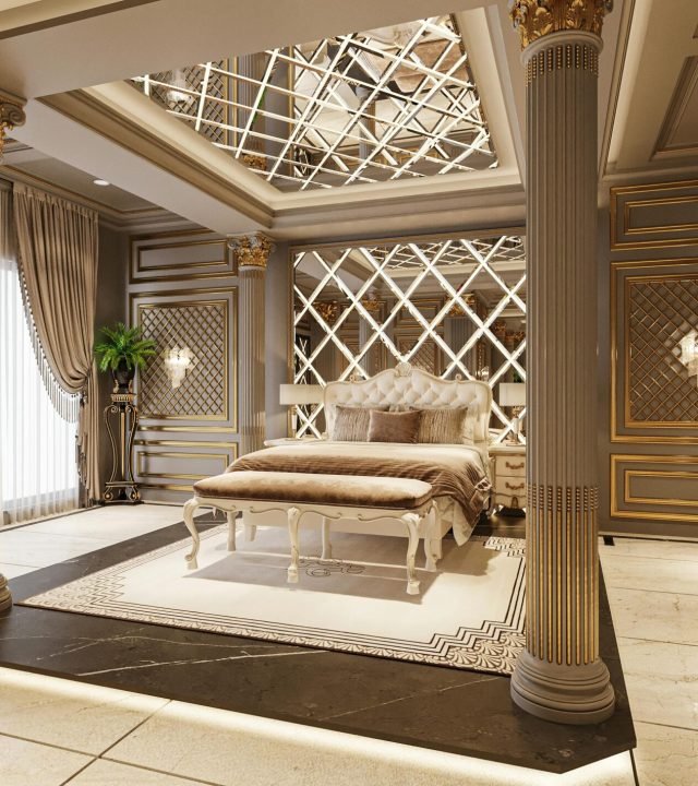 Elegant bedroom featuring classic furnishings, gold accents, and dramatic lighting.